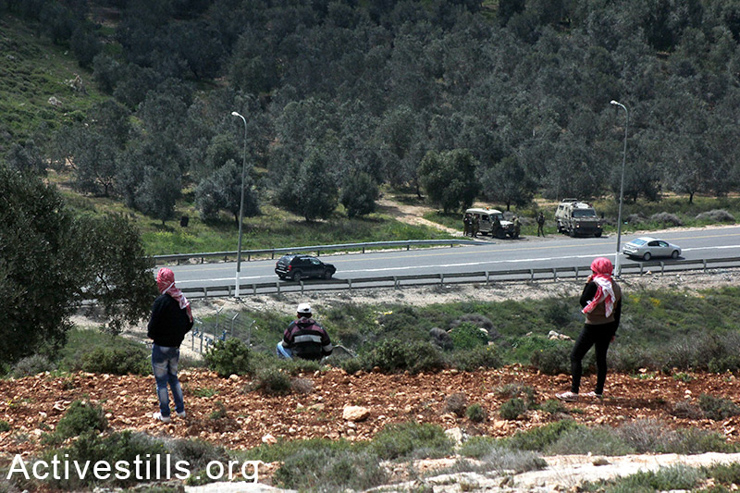 Palestinians look toward Road 60. The main road of Qaryut village, which connects the village with Road 60, is closed by Israeli forces. This adds 20 kilometers to the daily journey of villagers.  (photo: Activestills.org)