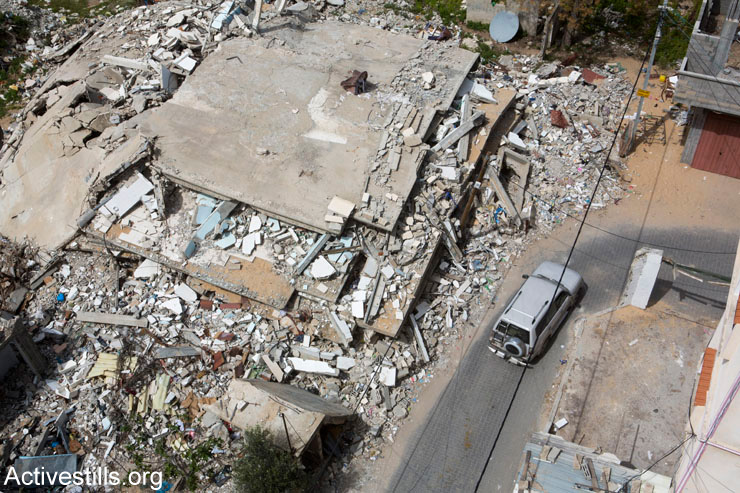 The ruins of a four-story building belonging Abdul Jawad Mheesin, which was destroyed during the last Israeli military offensive, Gaza Strip, March 25, 2015. The attack killed Nisreen Ahmad (38) and her son Hussein (8), who were living in the adjacent home, as well as Suheir Abu Meddin (43), who was living in the tower and went back inside to take some belongings minutes after a warning missile was fired.