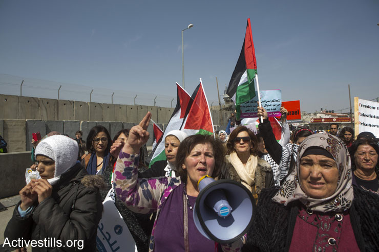Palestinian women march toward the Qalandia checkpoint separating Ramallah and Jerusalem. Israeli soldiers broke up the joint Israeli-Palestinian protest against the occupation, a day before International Women’s Day, March 7, 2015. (Anne Paq/Activestills.org)