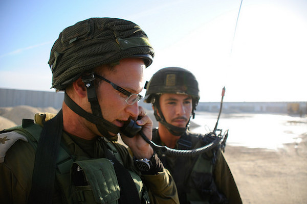 An Israeli soldier uses a two-way radio during an exercise during the Gaza border, November 19, 2014. (Amit Shechter/IDF Spokesperson)