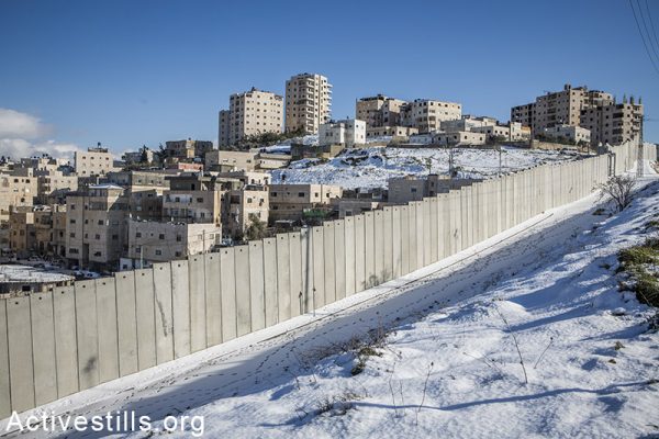 The Separation Wall and the Sh'uafat Refugee Camp are seen following a snow storm, on February 20, 2015. Yotam Ronen / Activestills.org