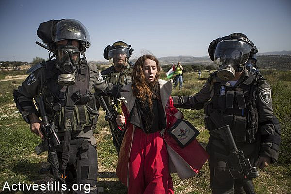 Israeli border policemen arrest an Israeli protester during a protest marking ten years for the struggle against the Wall in the West Bank village Bil'in, February 27, 2015. Yotam Ronen / Activestills.org