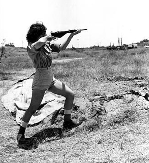 A female officer in charge of the range at the Hen women's corps camp near Tel Aviv, Palestine, gives a demonstration in the handling of a Sten gun on June 15, 1948 in the Arab-Israeli War.  Although non-combatants, members the new women's Army in Israel are taught to use guns for defense. (AP Photo/Public Domain)
