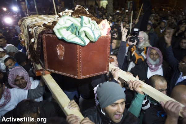 Mourners carry the body of Sami al-Jaar during his funeral, in the city of Rahat, Negev Desert, January 18, 2015. (Photo by Oren Ziv/Activestills.org)