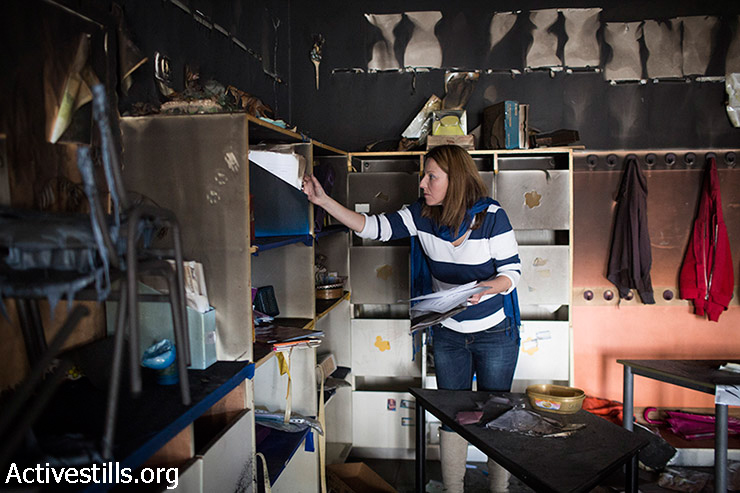 A teacher inspects the damage in the aftermath of an arson attack that targeted first-grade classrooms at a bilingual Jewish-Arab school near the Palestinian neighbourhood of Beit Safafa, in southern Jerusalem, November 30, 2014. Anti-Arab slogans were scrawled on the walls in Hebrew reading: "Death to Arabs", and "There's no coexistence with cancer."