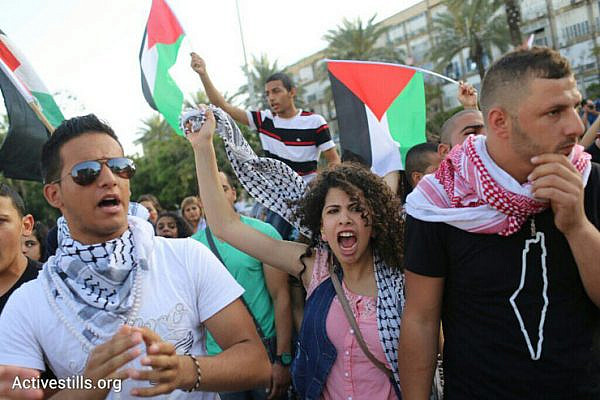 Thousands of Palestinian citizens of Israel demonstrate against the government's housing discrimination and policy of home demolitions, Rabin Square, Tel Aviv, April 28, 2015. (Oren Ziv/Activestills.org)