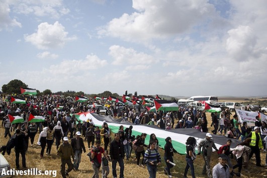 Approximately 10,000 people take part in the annual ‘March of Return’ to the demolished Palestinian village of Khubayza in northern Israel. Although Nakba Day is commemorated on May 15, the 'March of Return' occurs on the same day Israel celebrates its Independence Day, according to the Hebrew calendar. April 16, 2013. (Photo by Oren Ziv/Activestills.org)