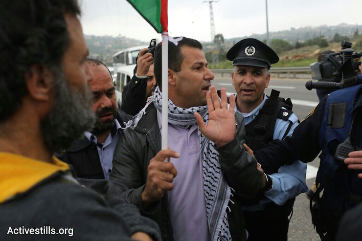 Israeli security forces stop Palestinian protesters from reaching the site of the ‘Biblical Marathon,’ West Bank, April 9, 2015. (Photo by Oren Ziv/Activestills.org)