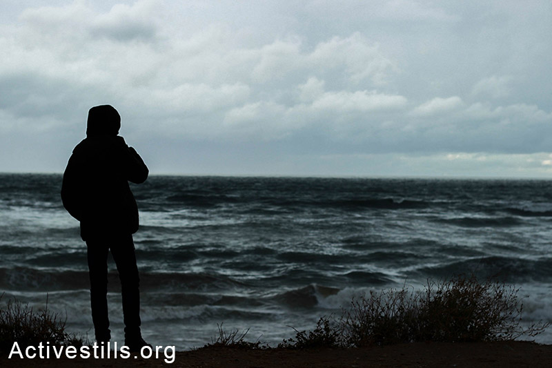 A man faces the wind on a stormy day on the Gaza coast. (Photo by Basel Yazouri/Activestills.org)