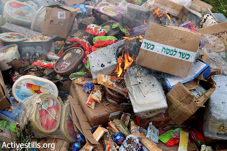 Palestinians burn Israeli products confiscated from a truck belonging to the Israeli company Strauss Group Ltd, Nablus, West Bank, March 11, 2015. Activists in the Fatah movement of Palestinian President Mahmoud Abbas announced plans to boycott Israeli products last month after Israel halted transfer of vital tax revenues to Abbas's cash-strapped Palestinian Authority. Israel took that step after the Palestinians joined the International Criminal Court to seek war crimes charges against Israel. (photo: Activestills.org)
