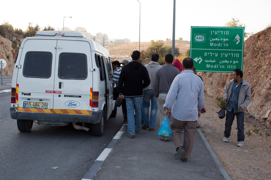 Palestinian workers enter an unlicensed service taxi in the West Bank. (Activestills.org)