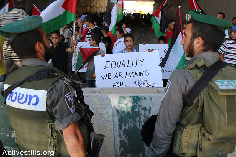 Palestinians from the West Bank village of Al Zaeem call for the opening of the Separation Wall gate that leads from Jerusalem to the village, May 8, 2015. The gate is held closed by Israeli authorities for over two weeks. Ahmad al-Bazz / Activestills.org