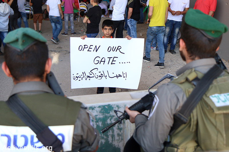 Palestinians from the West Bank village of Al Zaeem call for the opening of the Separation Wall gate that leads from Jerusalem to the village, May 8, 2015. The gate is held closed by Israeli authorities for over two weeks. Ahmad al-Bazz / Activestills.org