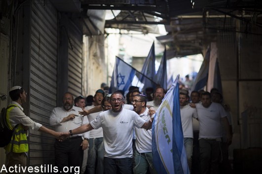 Israel youth walk in Jerusalem's old city, as they take part in the flags march, to celebrate 48 years for the occupation of East Jerusalem May 17, 2015.