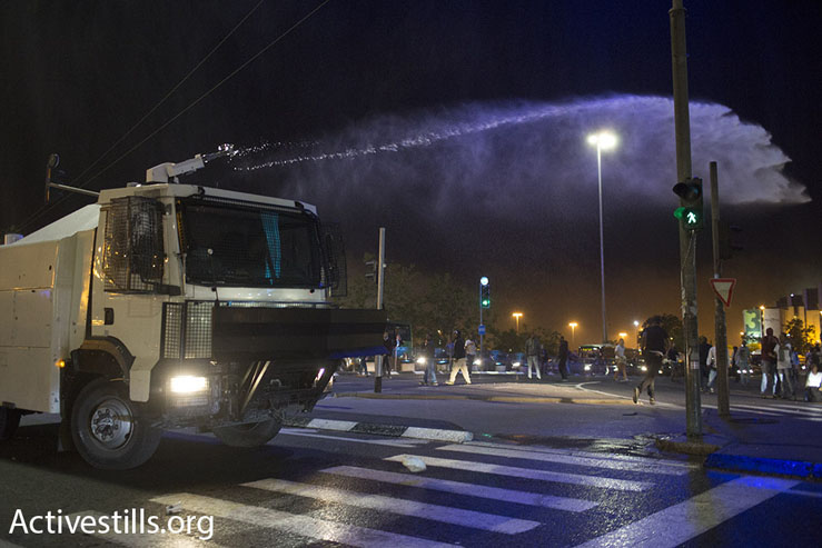 Israeli police shoot putrid ‘skunk’ water a demonstration against police brutality, Jerusalem, April 30, 2015. (Oren Ziv/Activestills.org)