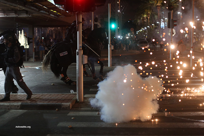 A police horse reacts to a flurry of stun grenades thrown by police at a demonstration by Israelis of Ethiopian descent against police in Tel Aviv’s Rabin Square, May 3, 2015. (Activestills.org)