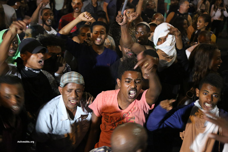 Protesters sit in the road at a demonstration by Israelis of Ethiopian descent against police in Tel Aviv’s Rabin Square, May 3, 2015. (Activestills.org)