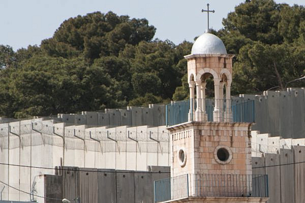 Church based activists in the U.S. are listening to their Palestinian Christian counterparts. Here, the Greek Orthodox Church of Saint Lazarus rises near the Israeli Separation Wall dividing Palestinian neighborhoods on the Mount of Olives in East Jerusalem. (photo: Ryan Rodrick Beiler/Activestills.org)