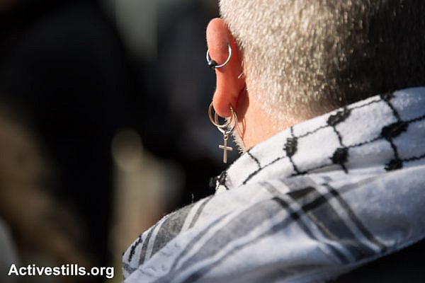 International Christian activists join Palestinians for a Catholic mass in a West Bank olive grove as a form of nonviolent resistance against the Israeli separation barrier that threatens to further divide land belonging to the town of Beit Jala, March 14, 2014.