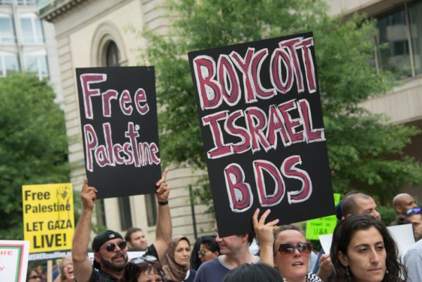 Protesters hold signs calling for boycott, divestment and sanctions (BDS) during a Washington, D.C., protest against Israel's offensive on Gaza, August 2, 2014. (photo: Ryan Rodrick Beiler/Activestills.org)