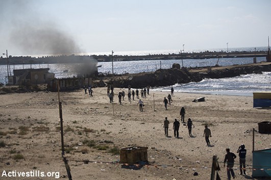 Smoke rises from Gaza shore after missiles launched by the Israeli navy. 4 children from the Bakr family were killed while they were playing on the beach. The names of those killed: Ahed Atef Bakr, 10; Zakaria Ahed Bakr, 10; Mohamed Ramez Bakr, 11 and Ismael Mohamed Bakr, 9. Eye witnesses said that three of the children where hit while escaping. Following the incident, the army spokesman announced that an investigation of the incident will be opened. On June 2015, the Israeli investigation into the case was closed with Israel’s Advocate General’s office saying the attack, was a “tragic accident”. The attack occurred in front of many international media crew and was extensively documented. (Anne Paq/Activestills.org)
