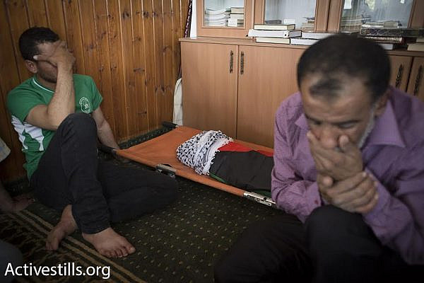 Palestinian relatives mourn the death of 18-month-old Ali Dawabshe, after he was killed in an arson attack by Jewish settlers, Duma, West Bank, July 31, 2015. (photo: Oren Ziv/Activestills.org)