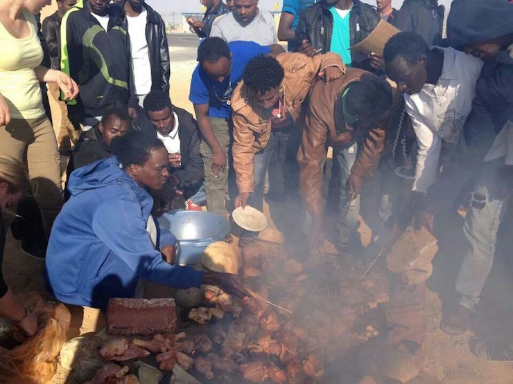 Asylum seekers cook meat outside the prison walls, photo provided to Activestills in 2014.