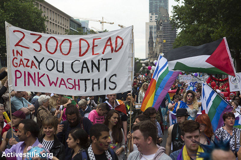 Activists display banners next to Israeli supporters at Christopher Street Day (CSD) parade in Berlin, as part of an action against pinkwashing, Germany, June 27, 2016. The protesters accuse Israel of using LGBTQI rights issues to mask what protesters claim is the "ethnic cleansing and genocide in Palestine." In their call for protest, they write: "Pinkwashing is used extensively by the Israeli government. Israel claims they support LGBTQI rights, in order to divert attention away from their human rights cromes against Palestinians..›e will not allow the Israeli war machine to use LGBTQI rights as a justification for its oppression of others". Every year, Israel has a prominent place in the CSD parade, distrubuting Israeli flags coloured with the rainbow colours. Activists display banners next to Israeli supporters at Christopher Street Day (CSD) parade in Berlin, as part of an action against pinkwashing, Germany, June 27, 2016. The protesters accuse Israel of using LGBTQI rights issues to mask what protesters claim is the "ethnic cleansing and genocide in Palestine." In their call for protest, they write: "Pinkwashing is used extensively by the Israeli government. Israel claims they support LGBTQI rights, in order to divert attention away from their human rights cromes against Palestinians..â€ºe will not allow the Israeli war machine to use LGBTQI rights as a justification for its oppression of others". Every year, Israel has a prominent place in the CSD parade, distrubuting Israeli flags coloured with the rainbow colours. (Activestills.org)