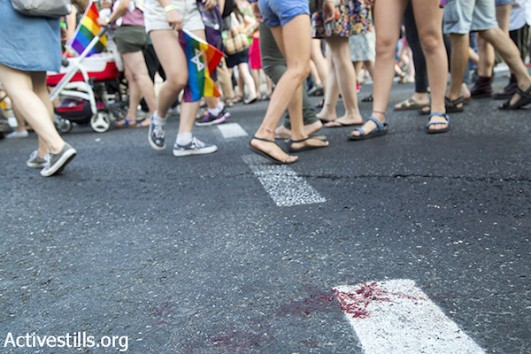 Blood is seen on the pavement following a mass stabbing attack against the Jerusalem LGBTQ Pride Parade in Jerusalem, July 30, 2015. (Keren Manor/Activestills.org)
