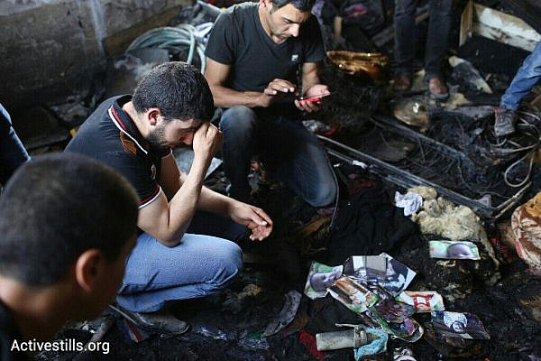 Palestinians mourn the death of Palestinian baby, Ali Saad Daobasa, who was killed by Israeli settlers in an overnight arson attack, Douma, West Bank, July 31, 2015. (photo: Oren Ziv/Activestills.org)
