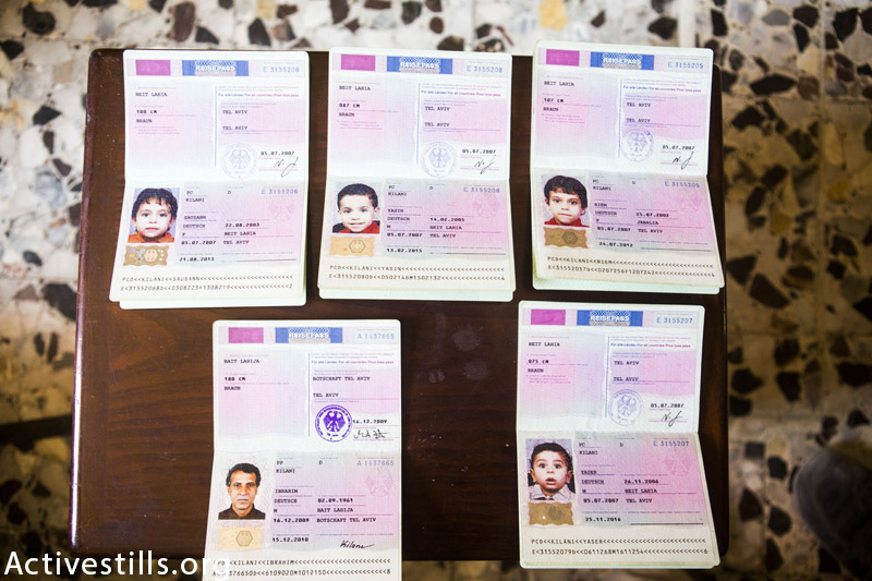 Photo of the German passports of Ibrahim al Kilani and four of his children, seen in their home in Beit Lahiya, Gaza Strip, September 18, 2014. Ibrahim Taghrid was killed together with his wife Taghrid and their five children in an Israeli attack on July 21, 2014, targetting the building they flew to in Gaza city. Ibrahim and her children hold German passports as Ibrahim was living in Germany for 20 years and was working there as an architect. They flew their home in Beit Layhia after they saw leftlets launched by the Israely army, urging the residents to go to Gaza city. (Anne Paq / Activestills.org) 