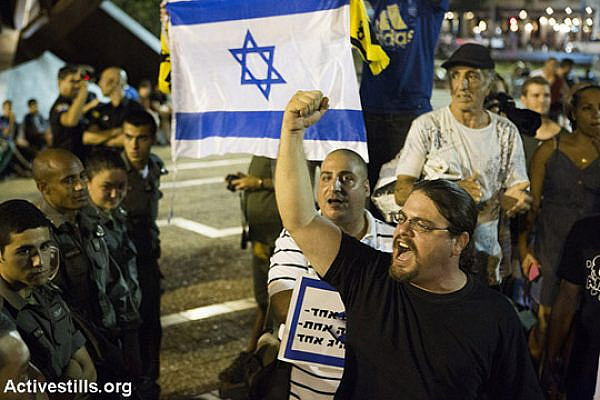 Israeli right-wing protesters shout at a pro-peace demonstration, Rabin Square, Tel Aviv, August 9, 2014. Hundreds gathered in Tel Aviv to protest Israel’s attack on Gaza, despite a police decision to revoke the demonstration permit. (Keren Manor/Activestills)