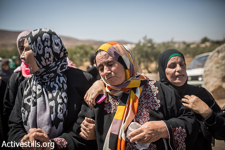 Mother of Saad Dawabsheh (center) reacts during her son's funeral procession, in the West Bank village of Duma, August 8, 2015. Saad Dawabsha and his toddler son Ali, 18-months-old, were burned to death in an arson attack by Jewish extremists on their house last week. Saad died of his injuries after a week in the hospital, while his wife still fights for her life. (Yotam Ronen / Activestills.org)