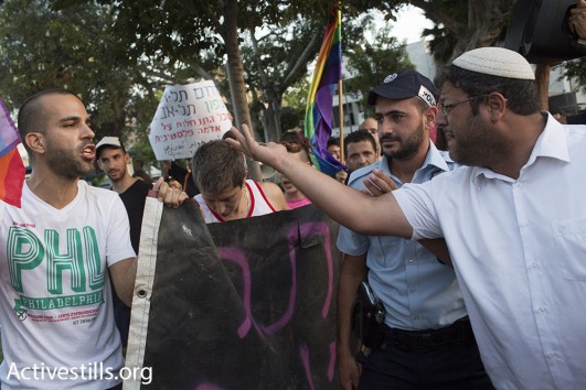LGBT activist confronts far-right  lawyer Itamar Ben Gvir in south Tel Aviv.  August 19, 2015. (Activestills)