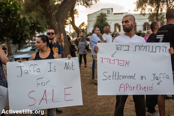 Local residents protest against the plan to build a new housing project for Jews only in the middle of the Palestinian neighborhood of Ajami, Jaffa, August 22, 2015. (Yotam Ronen/Activestills.org)