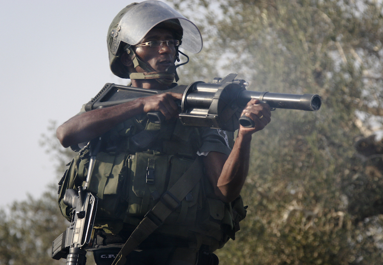 An Ethiopian Border Police officer fires tear gas canisters in the village of Nabi Saleh, 2010. (photo: Mati Milstein)