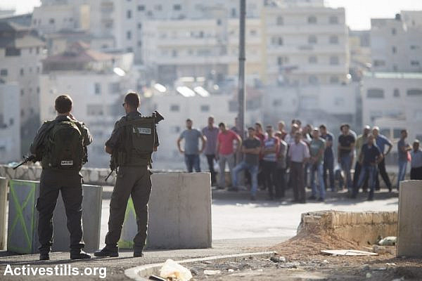 Israeli Border Police officers man a checkpoint for Palestinians leaving the East Jerusalem neighborhood of Issawiya, October 15, 2015. (Oren Ziv/Activestills.org)