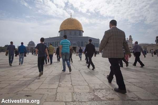 Palestinian worshippers walk toward the Dome of the Rock at Al-Aqsa Mosque compound before Friday prayers, the Old City of Jerusalem, November 14, 2014. (Faiz Abu Rmeleh/Activestills.org)