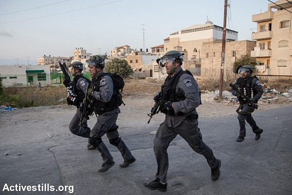 Israeli policemen run during clashes in Sh'uafat neighbourhood in Jerusalem October 5, 2015. Violence in the Israeli-occupied West Bank and Jerusalem has intensified in the past few weeks. (photo: Faiz Abu Rmeleh)