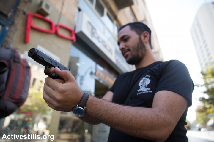 Israeli shows a tear gas gun he just bought at a gun shop in Jerusalem on October 15, 2015. Arms shop's owners report a rise in demand for wepons and other self deface gear as violance continues around Jerusalem. (photo: Yotam Ronen)