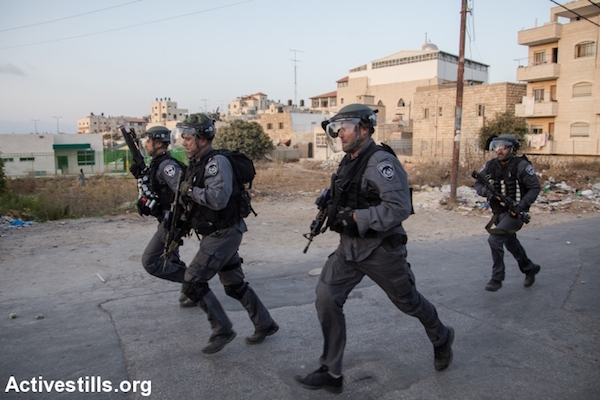 Israeli riot police run during clashes in the Shuafat neighborhood of East Jerusalem, October 5, 2015. (Faiz Abu Rmeleh/Activestills.org)