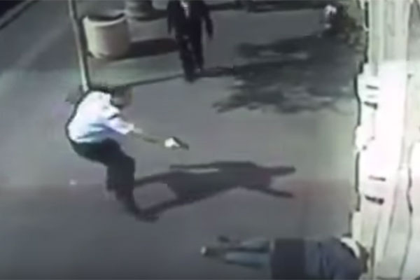 Screenshot of CCTV footage showing a man shooting a Palestinian teenage girl who stabbed an elderly Palestinian man in Jerusalem, November 23, 2015.