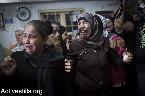 Relatives mourn during the funeral of 13-year-old Palestinian Ahmad Sharake, who was shot dead by Israeli soldiers during clashes near the Beit El Jewish settlement yesterday (Oct. 11), in the Palestinian West Bank refugee camp of Jalazun, on the outskirts of Ramallah, October 12, 2015. Sharake was killed during clashes that broke out as hundreds of Palestinians near Ramallah attempted to approach a road to throw stones and firebombs at settlers' cars. (Activestills.org)