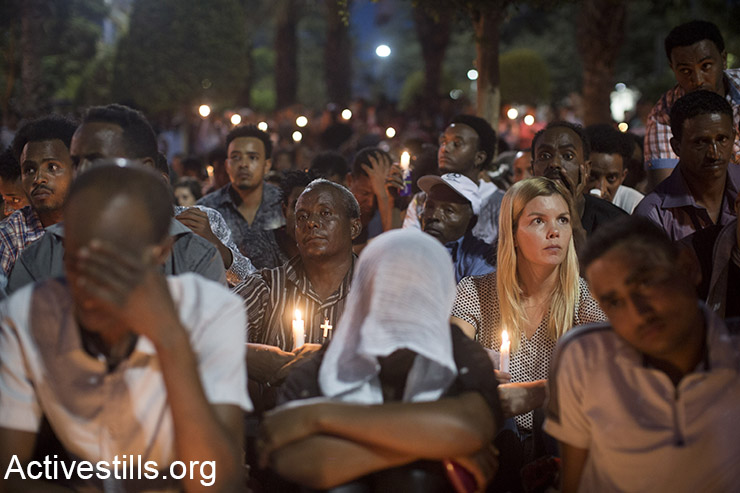 Members of the Eritrean community in Israel mourn on October 21, 2015 in Levinsky park in south Tel Aviv during a memorial ceremony for Eritrean asylum seeker Habtom Zarhum who died of his injuries after he was shot by an Israeli security guard at a bus station in the southern city of Beersheba after being mistaken for an assailant in an attack that killed an Israeli soldier. Zarhum, who was kicked by an angry mob after being shot will not be recognised as an official victim of terrorism. (Activestills.org)