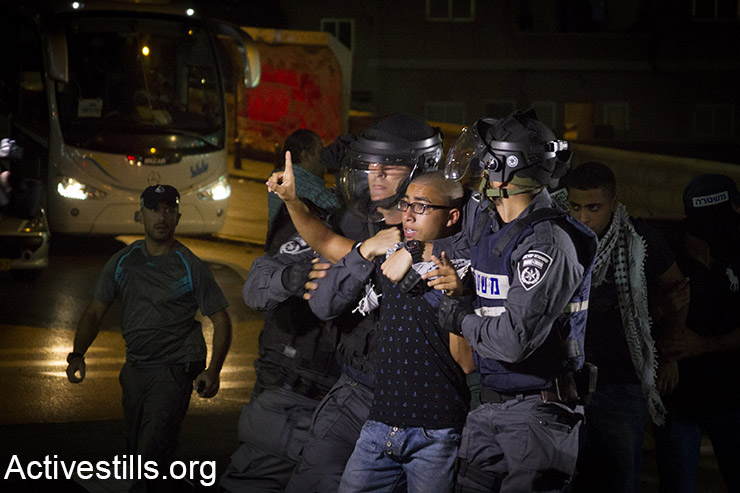 Policemen arrest a protester during clashes between youth and Israeli forces in the Palestnian town of Nazareth in northern Israel, on October 8, 2015. Tension rises in the past weeks in the region with over tent stubbing attacks and around the West Bank, Jerusalem and Palestinian towns in Israel. (Activestills.org)