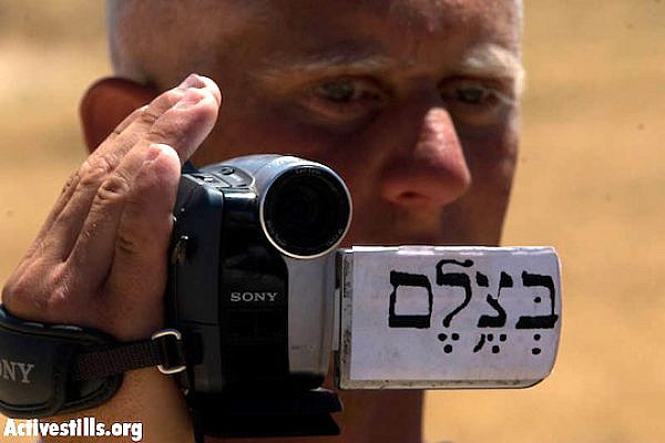 A Palestinian B'Tselem volunteer documenting a protest in the south Hebron Hills, June 14, 2008. (Oren Ziv/Activestills)