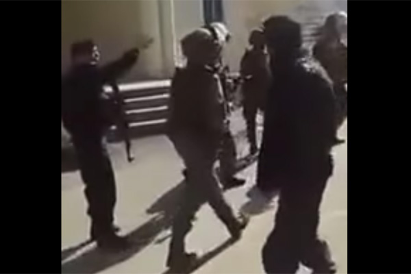 Screenshot of Palestinian police arguing with Israeli Border Police troops.