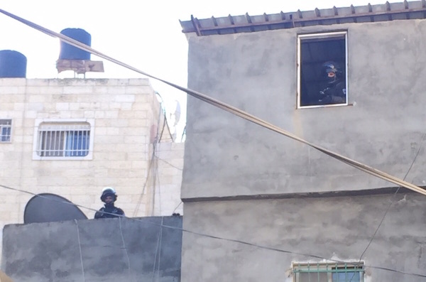 Israeli security forces are seen posted inside and on top of buildings during a home demolition in Shuafat refugee camp, East Jerusalem, December 2, 2015. (Israel Police)