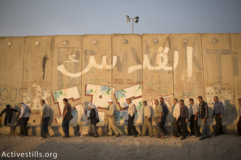 Palestinians cross the Qalandiya checkpoint between the West Bank city of Ramallah and Jerusalem on their way to pray at the Al-Aqsa Mosque in Jerusalem, on the second Friday of the Muslim holy month of Ramadan, June 26, 2015.  Activestills.org
