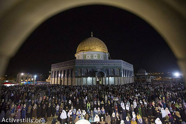 Palestinian Muslim worshippers pray overnight during Laylat al-Qadr, outside the Dome of the Rock in the Al-Aqsa mosque compound in Jerusalem's Old City, July 13, 2015. Layal al-Qadr, falls on the 27th day of the fasting month of Ramadan, marking the night Muslims believe the first verses of the Koran were revealed to the Prophet Mohammed through the archangel Gabriel. Activestills.org